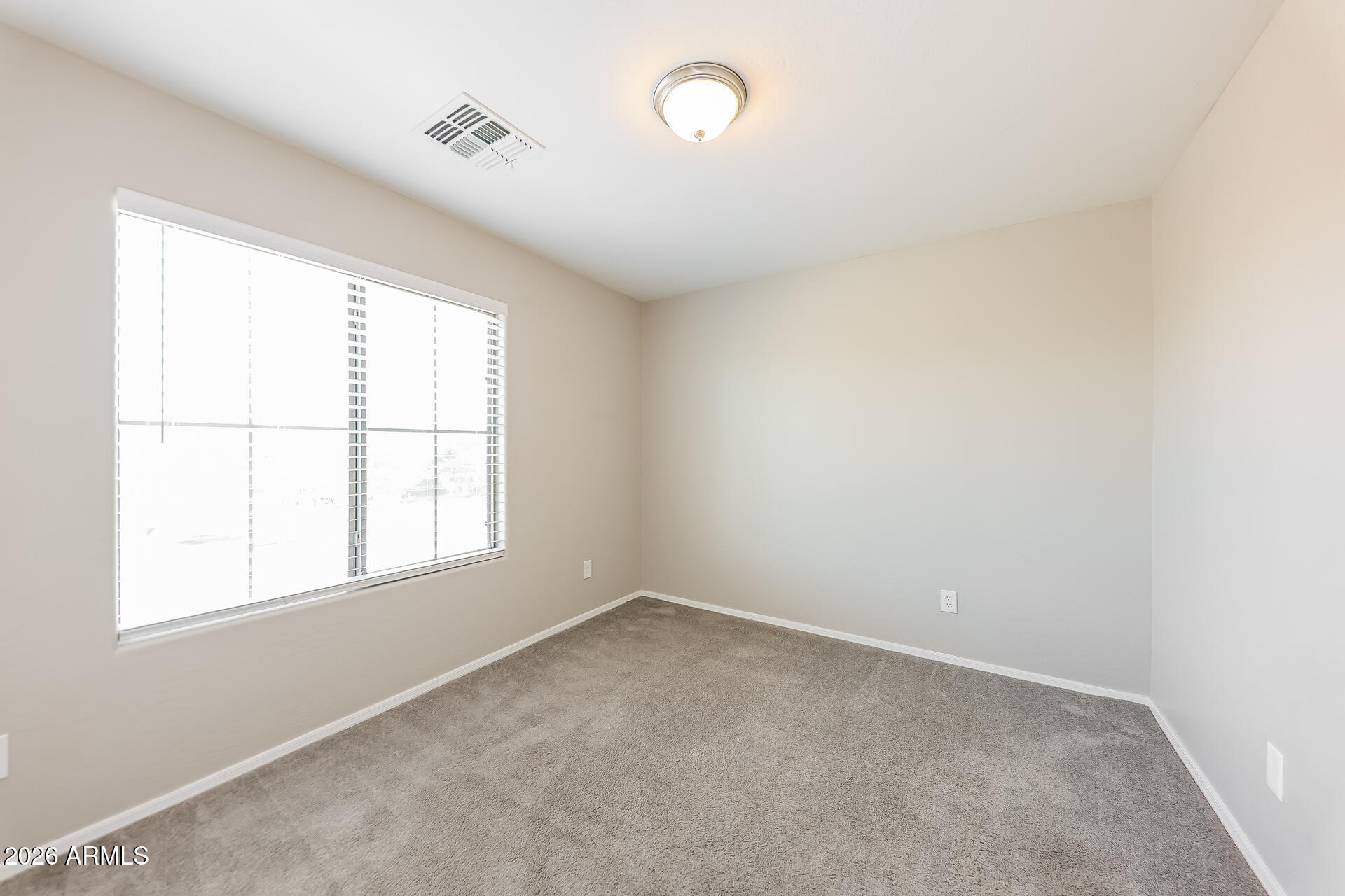 6716 South 36th Lane Phoenix, AZ 85041 - Photo 14 of 22 an empty room with a window