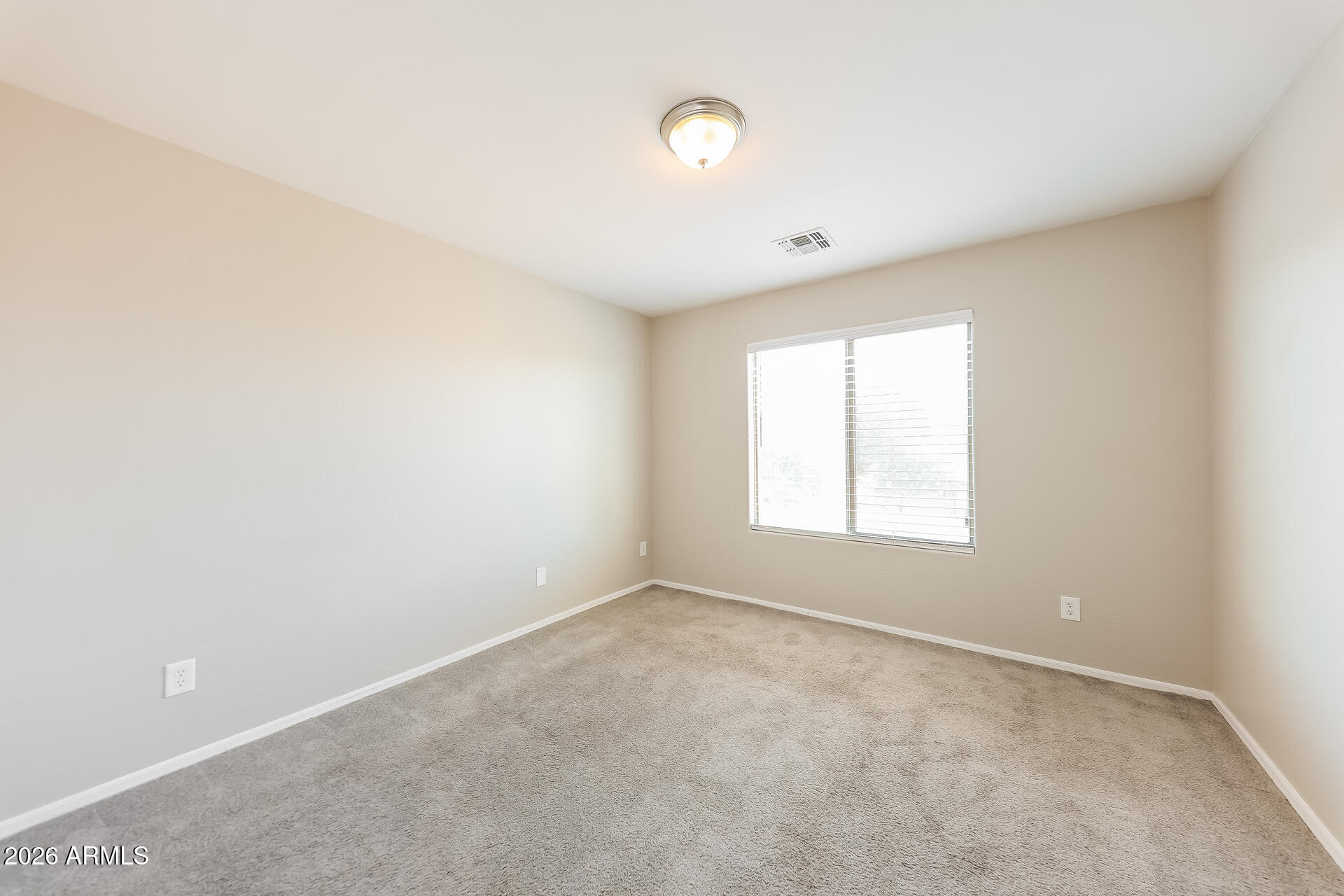 6716 South 36th Lane Phoenix, AZ 85041 - Photo 16 of 22 an empty room with a empty space and a window