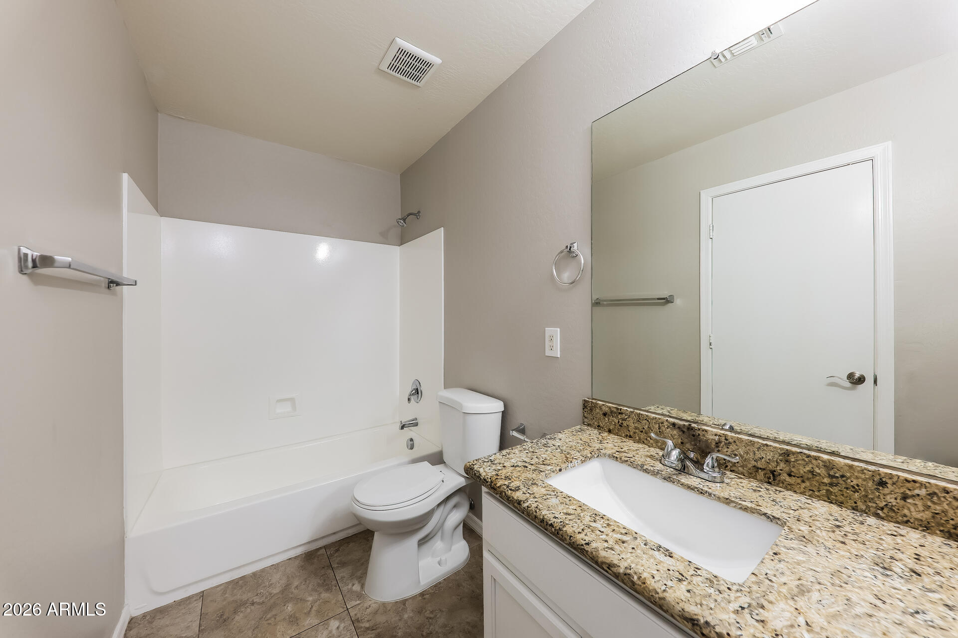 6716 South 36th Lane Phoenix, AZ 85041 - Photo 18 of 22 a bathroom with a granite countertop sink a toilet and shower