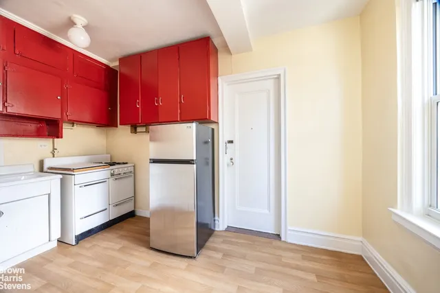 a kitchen with granite countertop a refrigerator and a sink