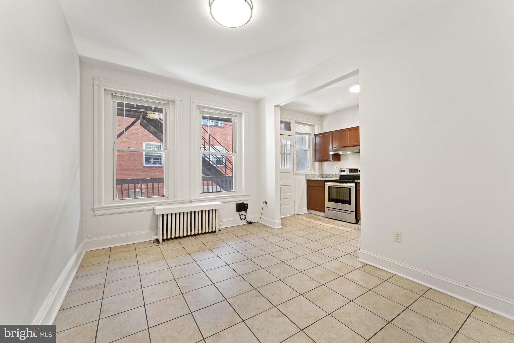 2707 11th Street Northwest Washington, DC 20001 - Photo 11 of 49 a view of a livingroom with an empty space and a window