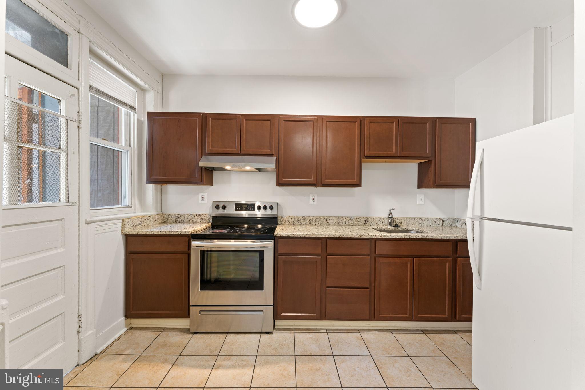 2707 11th Street Northwest Washington, DC 20001 - Photo 13 of 49 a kitchen with stainless steel appliances granite countertop a stove a refrigerator and a sink
