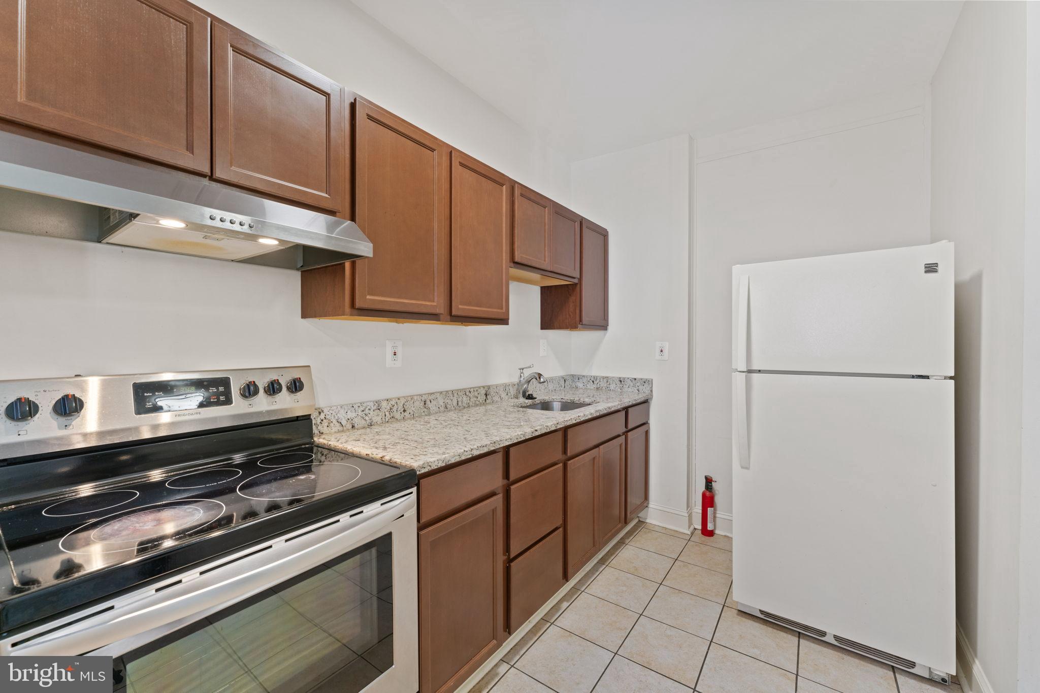 2707 11th Street Northwest Washington, DC 20001 - Photo 15 of 49 a kitchen with a stove and a refrigerator