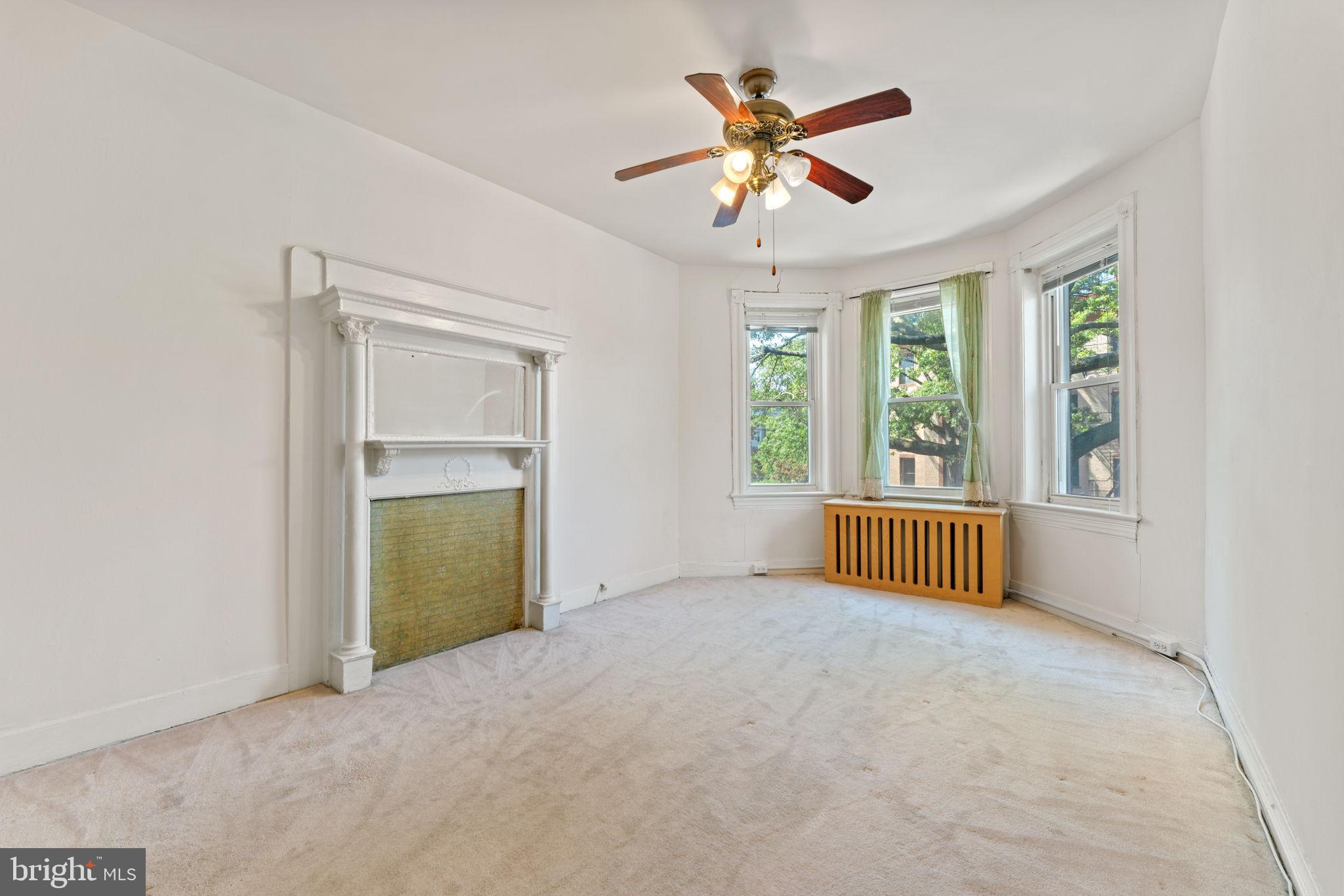 2707 11th Street Northwest Washington, DC 20001 - Photo 28 of 49 an empty room with chandelier fan and windows
