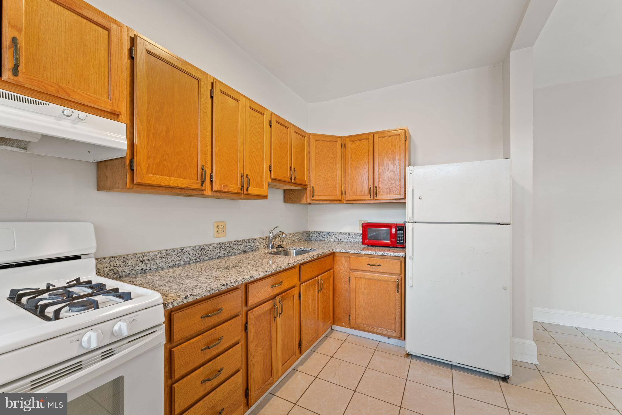 2707 11th Street Northwest Washington, DC 20001 - Photo 39 of 49 a kitchen with a sink a stove top oven and cabinets