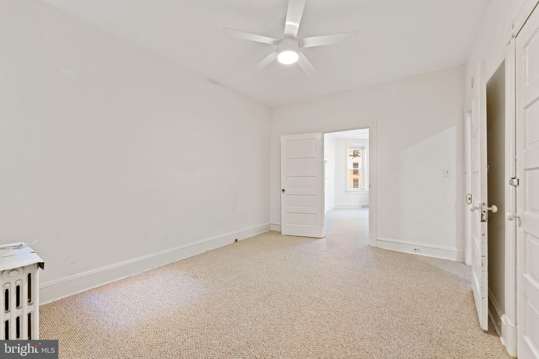 2707 11th Street Northwest Washington, DC 20001 - Photo 6 of 49 an empty room with closet and a ceiling fan
