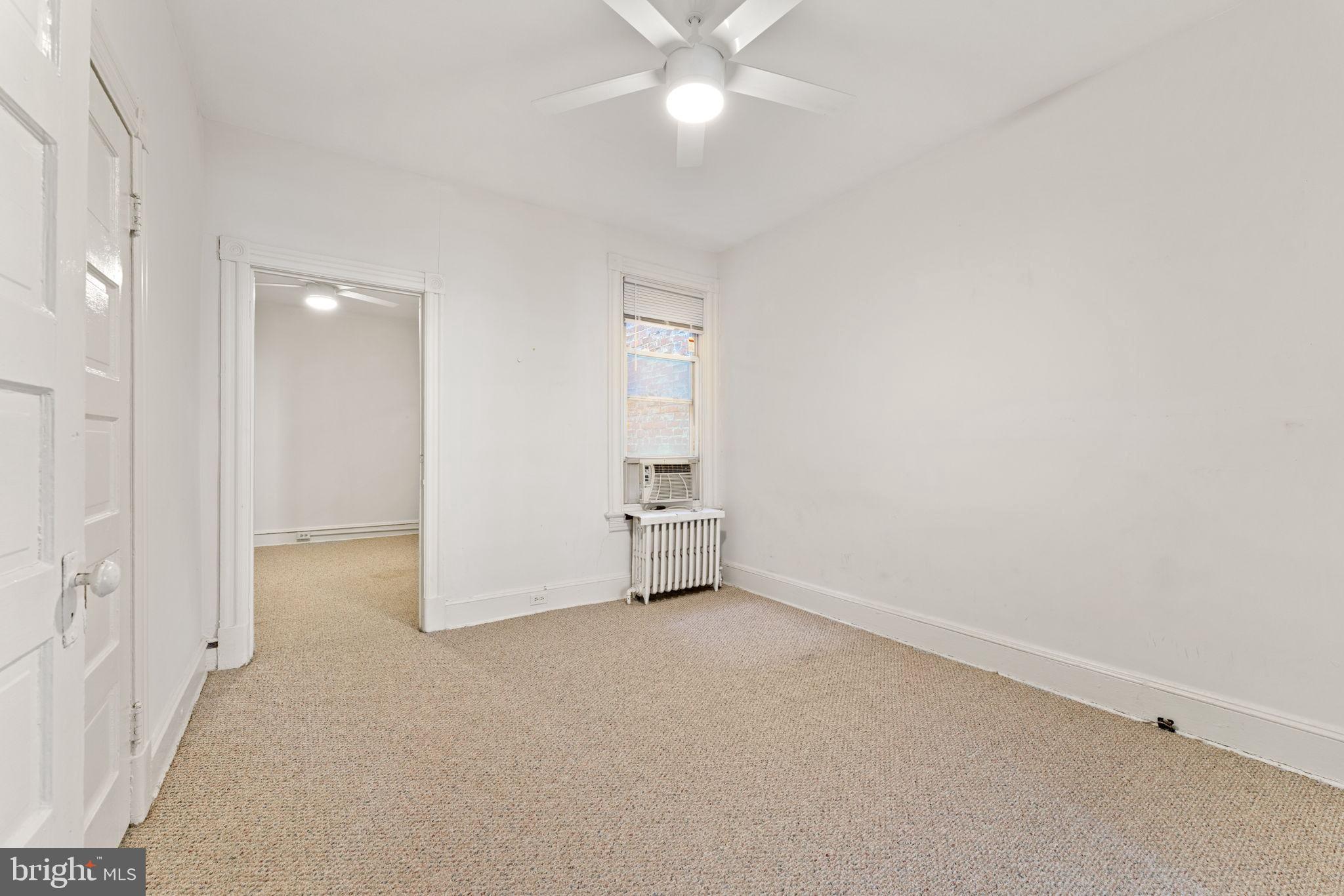 2707 11th Street Northwest Washington, DC 20001 - Photo 7 of 49 an empty room with a ceiling fan and a window