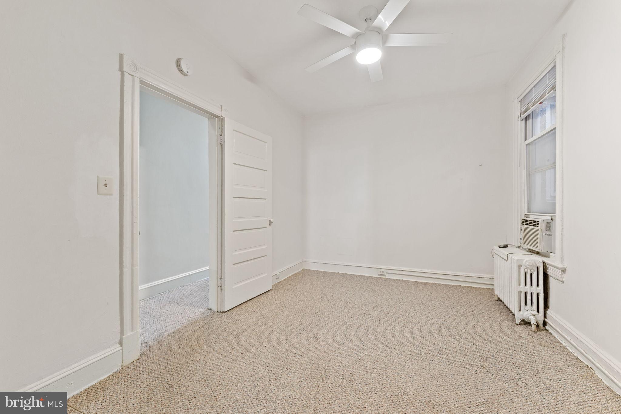 2707 11th Street Northwest Washington, DC 20001 - Photo 9 of 49 an empty room with staircase and ceiling fan