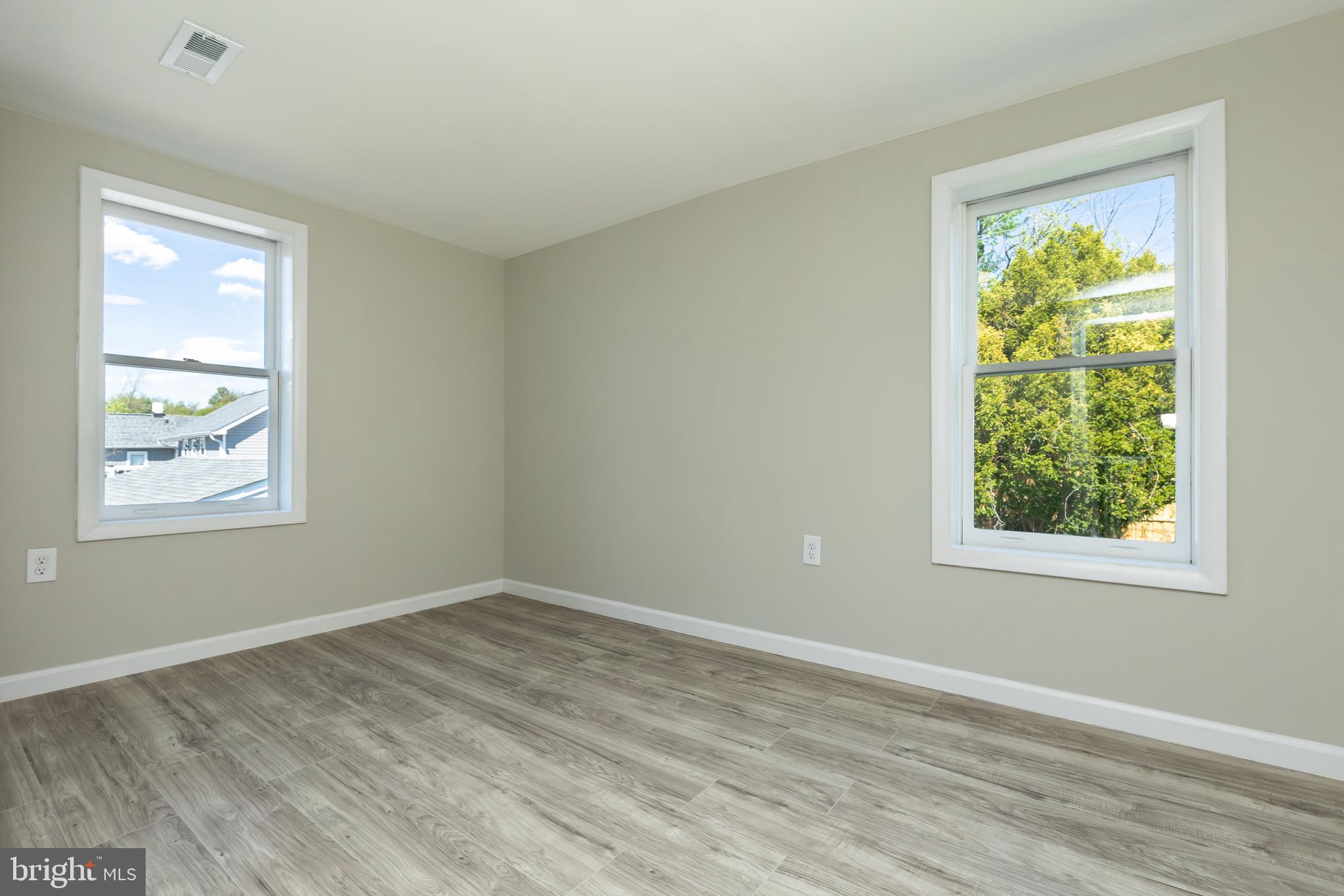 2407 Hammonds Ferry Road Halethorpe, MD 21227 - Photo 37 of 43 a view of an empty room with wooden floor and a window