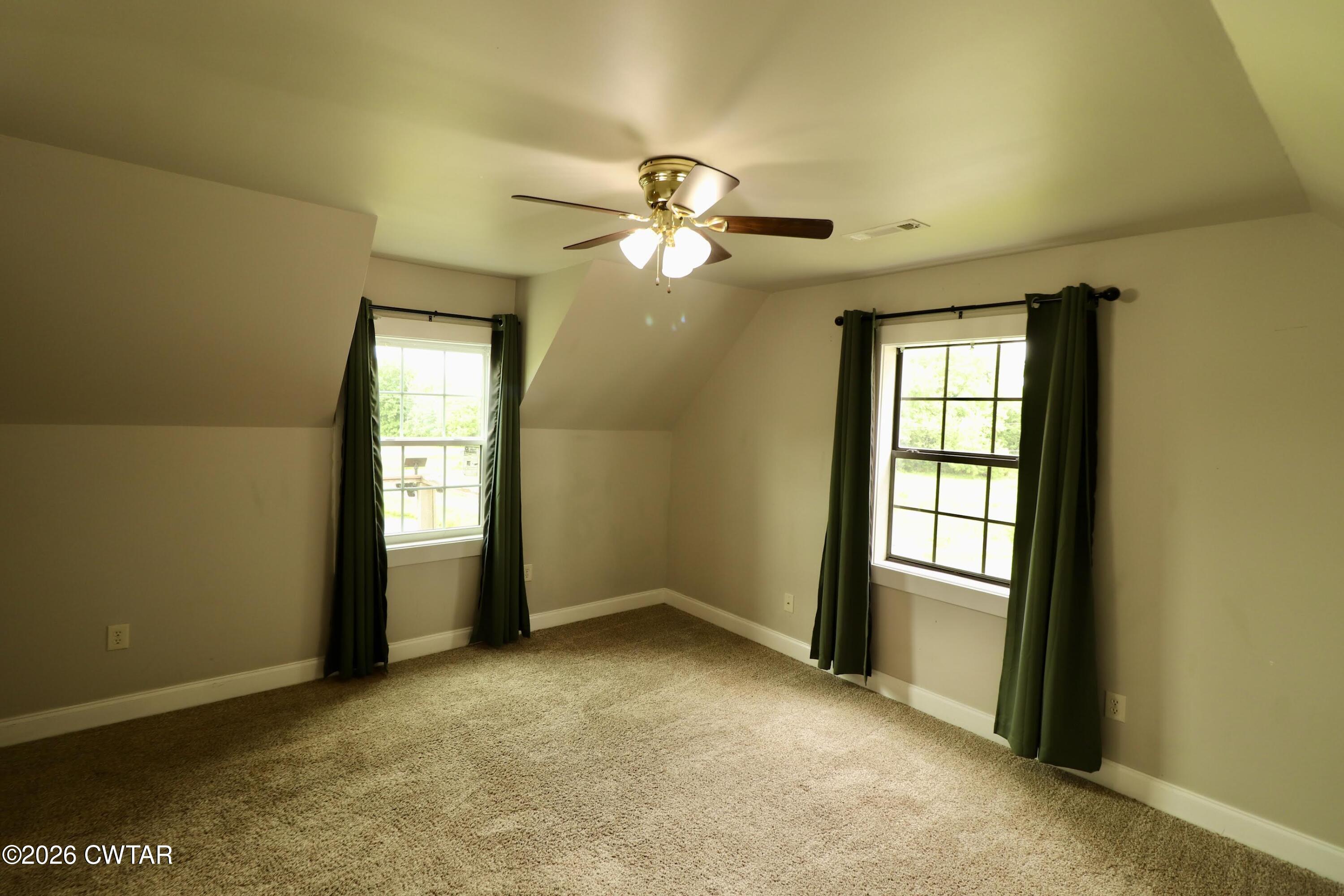 286 Baseline Road Kenton, TN 38233 - Photo 26 of 27 an empty room with chandelier fan and windows