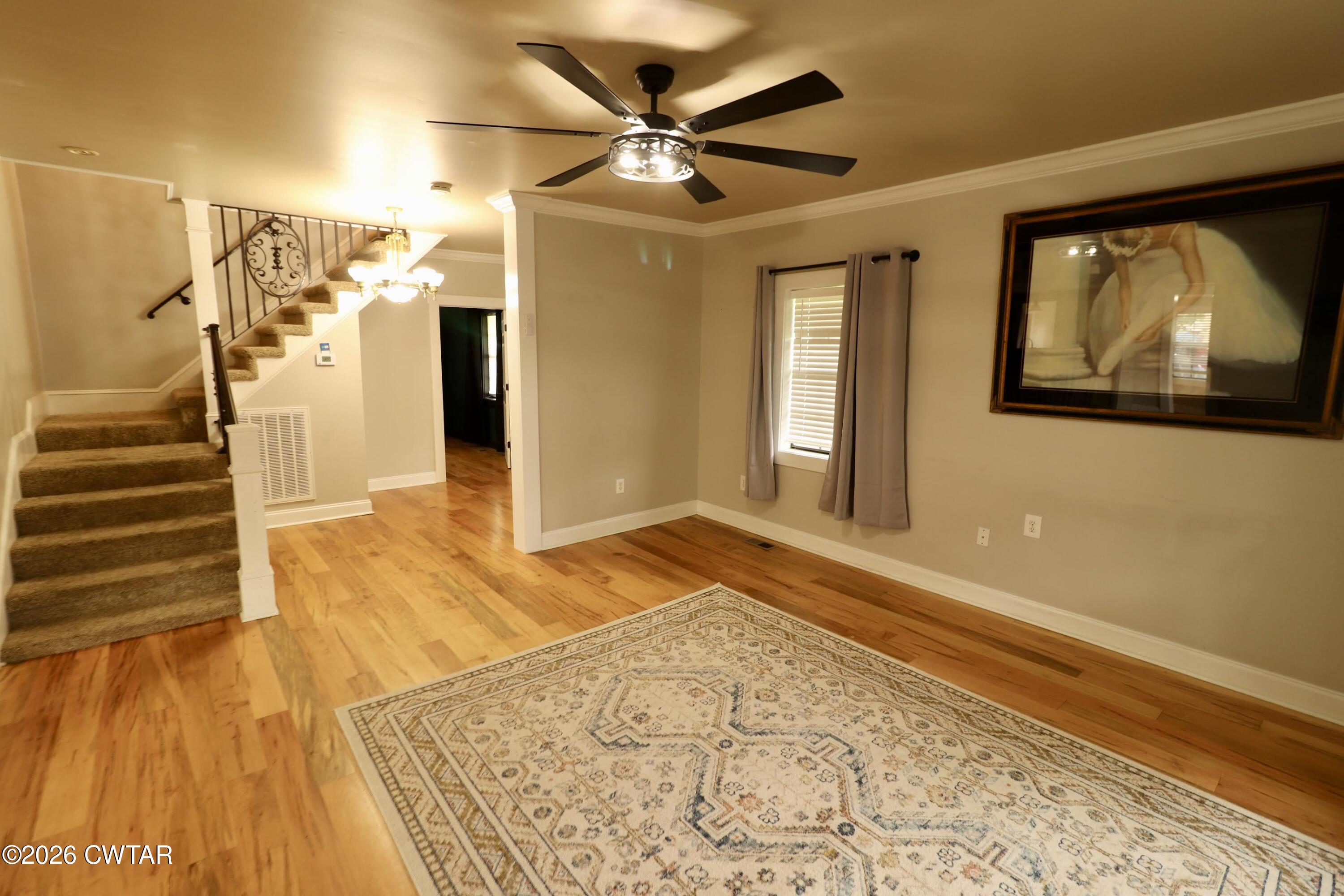 286 Baseline Road Kenton, TN 38233 - Photo 9 of 27 a view of a livingroom with wooden floor and a ceiling fan