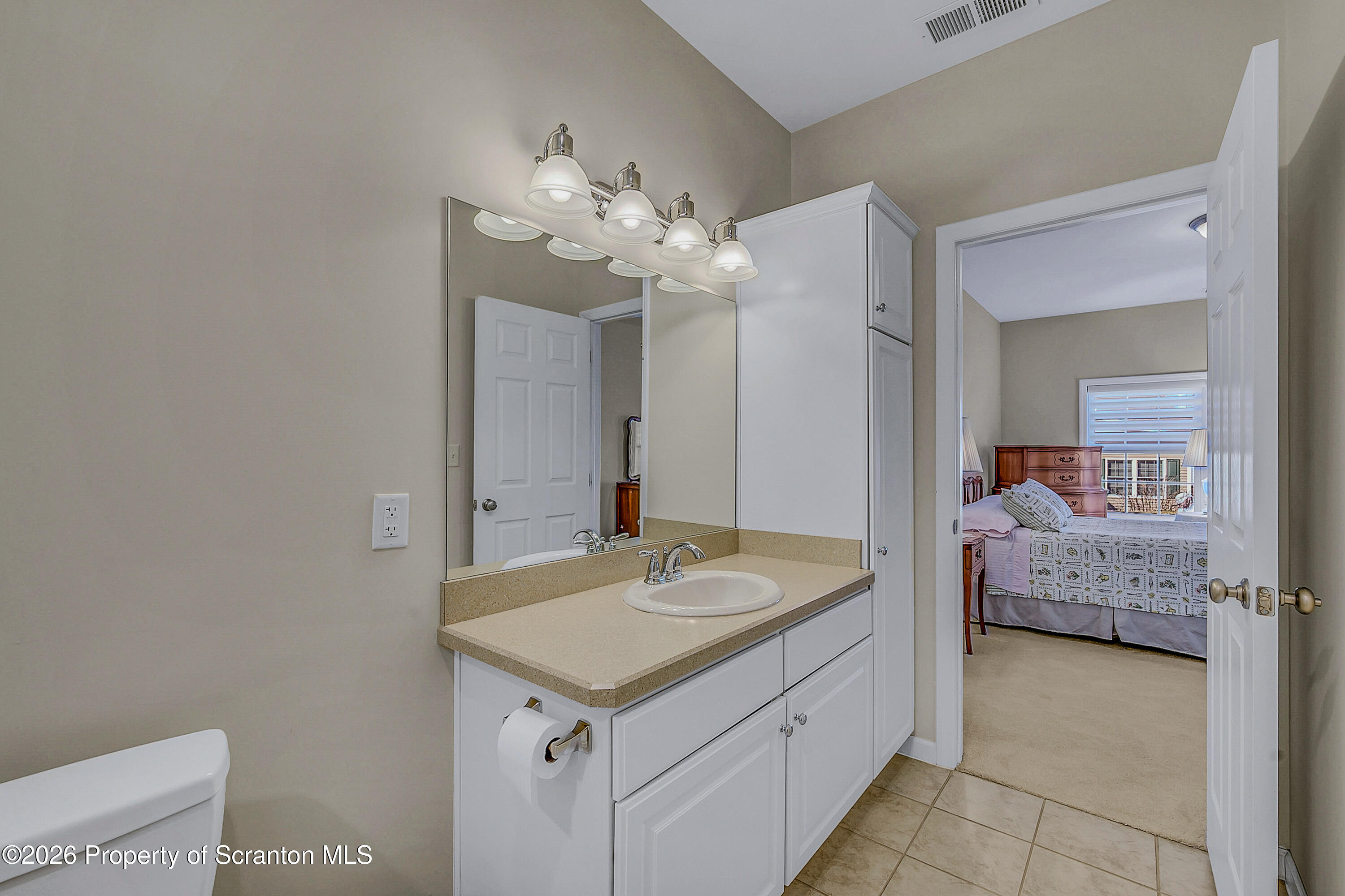 42 Wyndham Road Clarks Summit, PA 18411 - Photo 15 of 36 a en suite bathroom with a granite countertop sink and a mirror