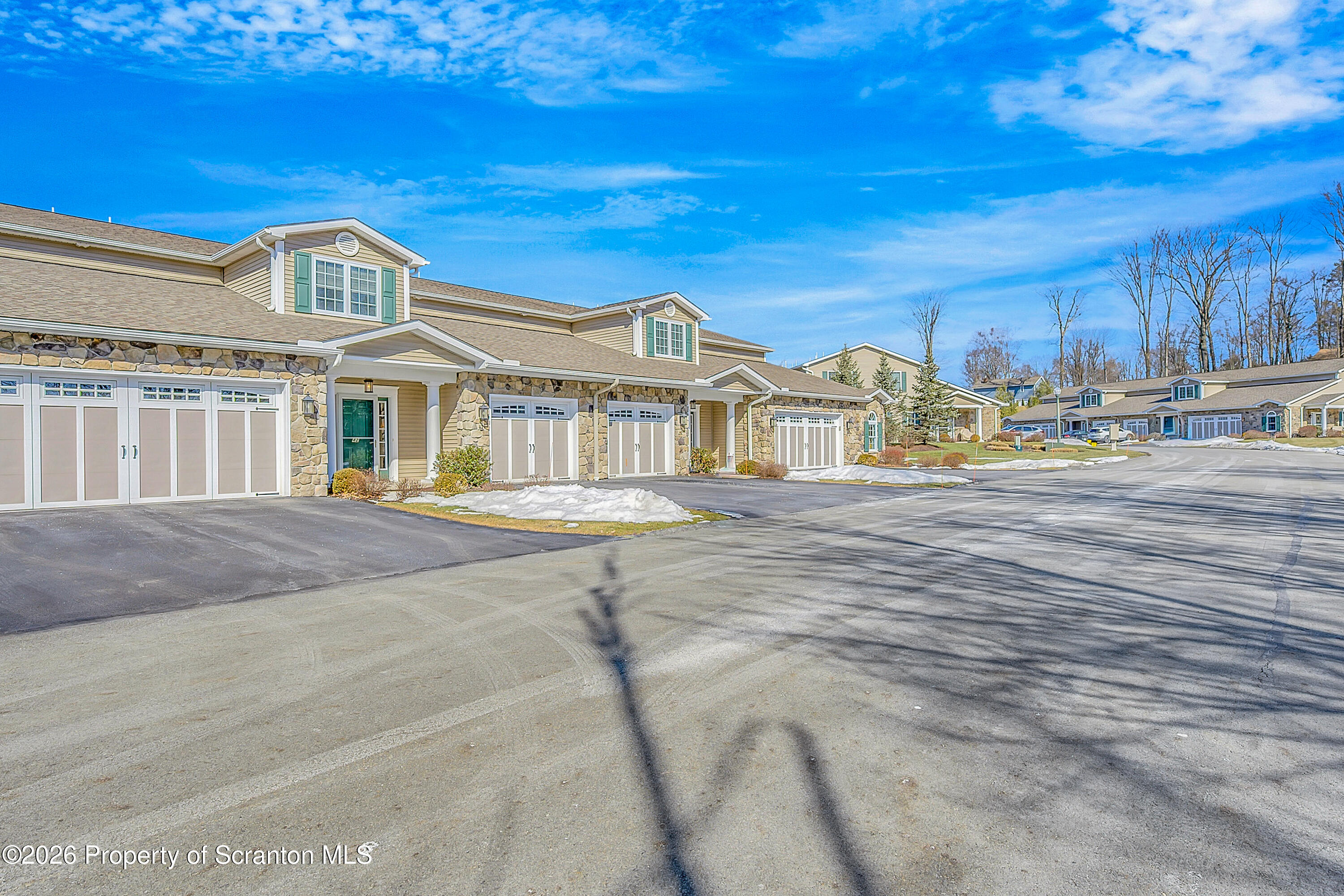 42 Wyndham Road Clarks Summit, PA 18411 - Photo 34 of 36 a view of a large building next to a yard with large trees