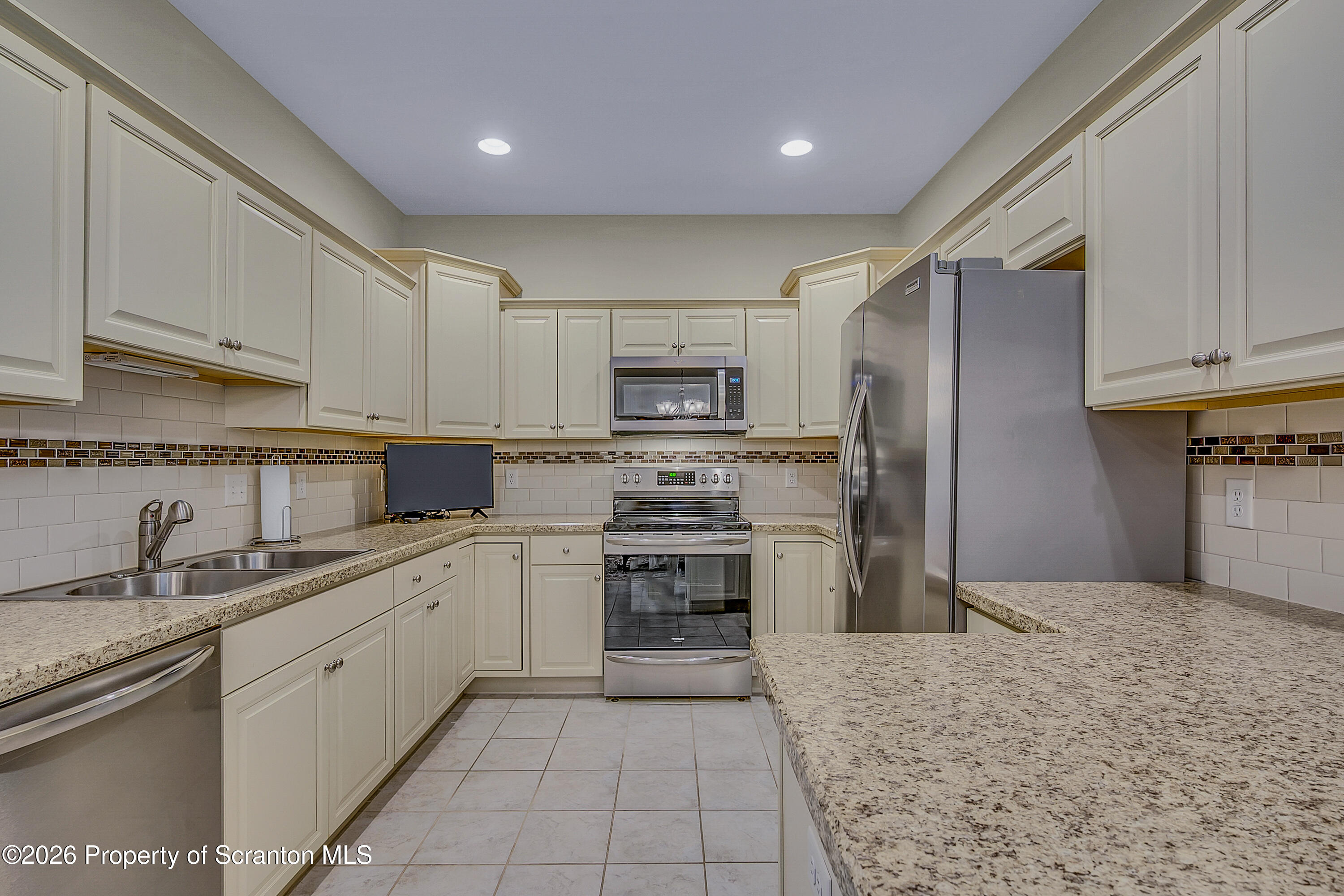 42 Wyndham Road Clarks Summit, PA 18411 - Photo 8 of 36 a kitchen with a sink stainless steel appliances and cabinets