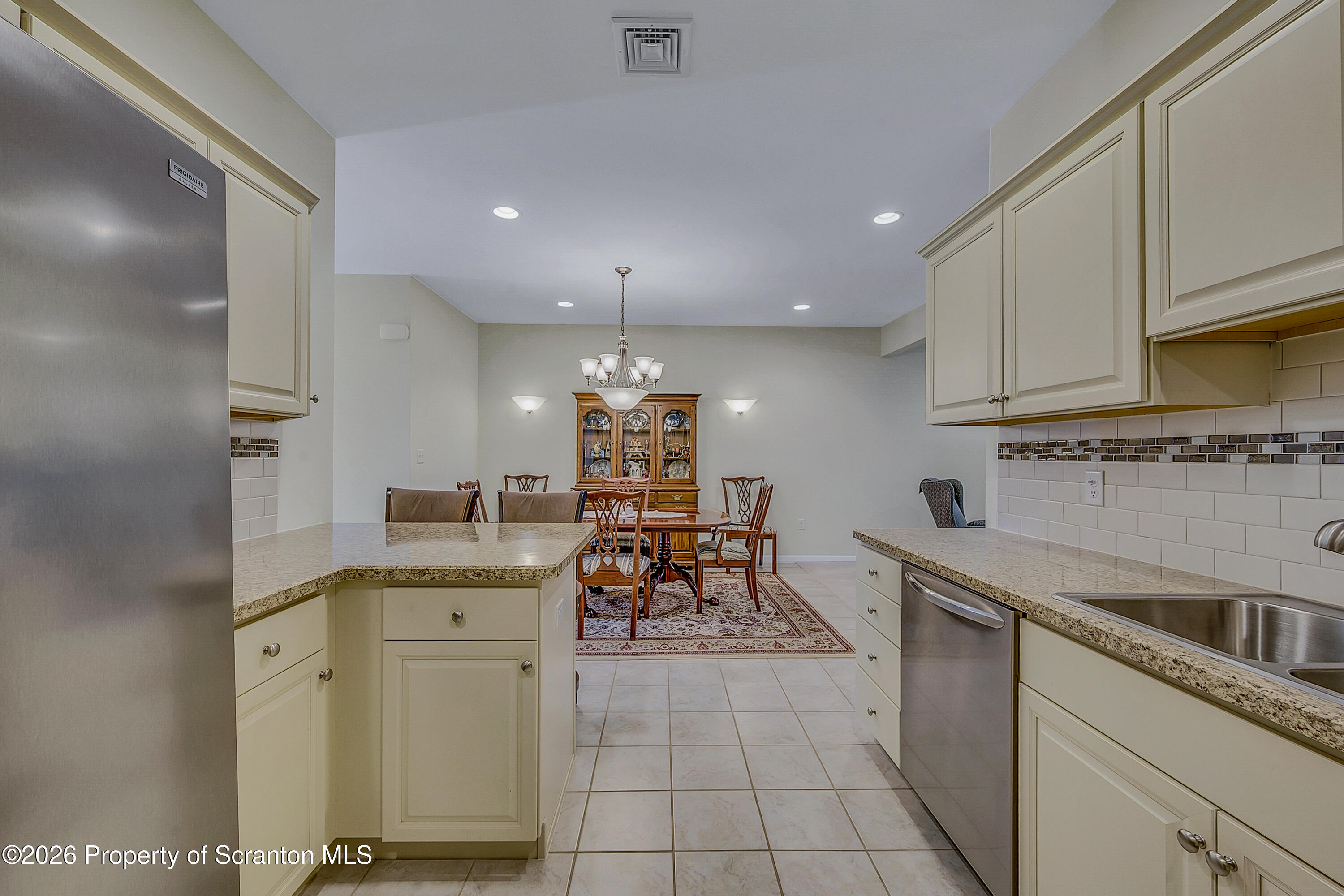 42 Wyndham Road Clarks Summit, PA 18411 - Photo 9 of 36 a kitchen with white cabinets and sink