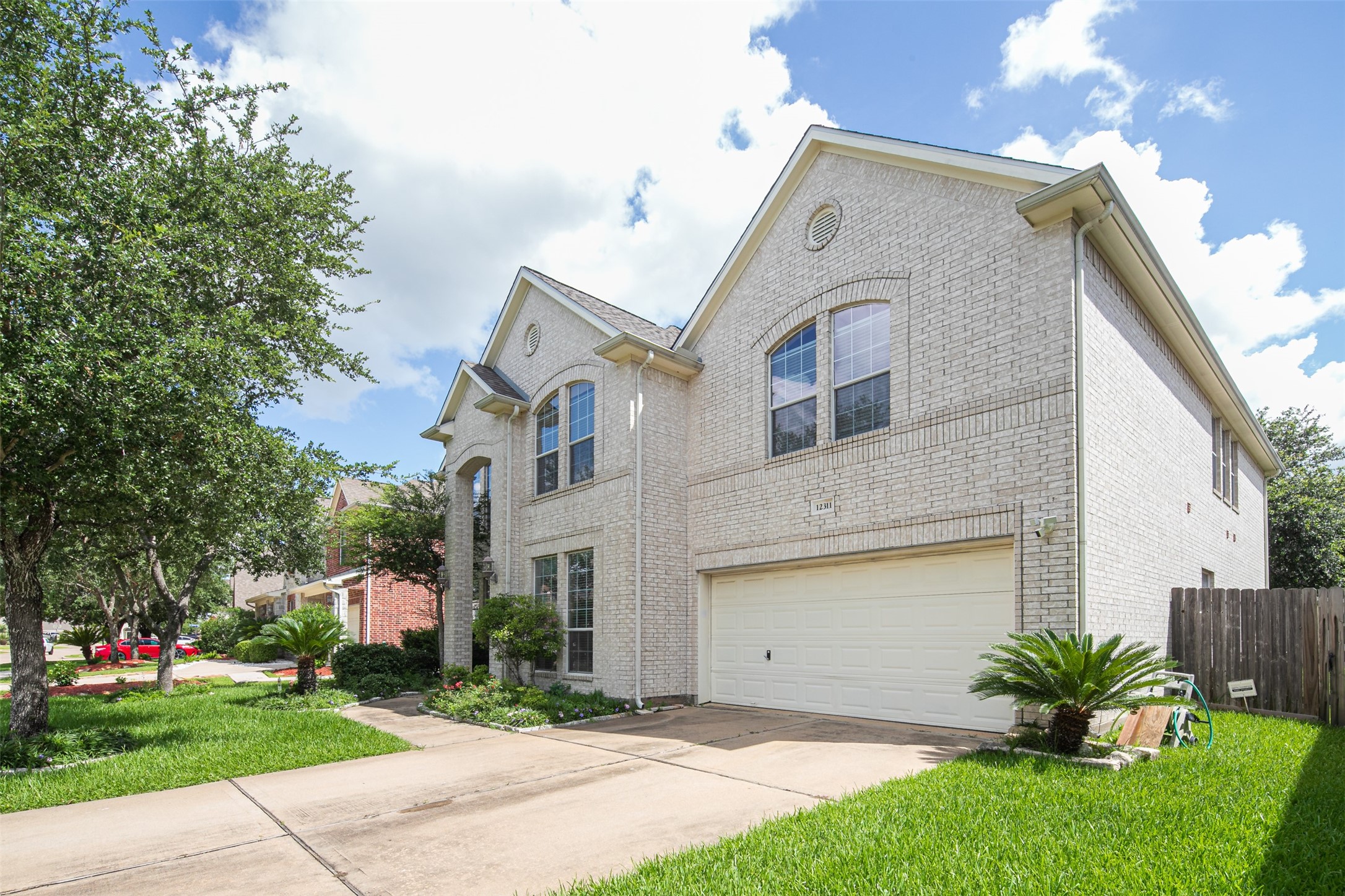 12311 Amanda Meadows Houston, TX 77089 - Photo 2 of 42 a front view of a house with a garden and plants