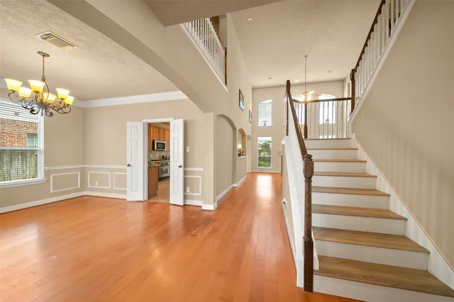 a view of entryway and hall with wooden floor