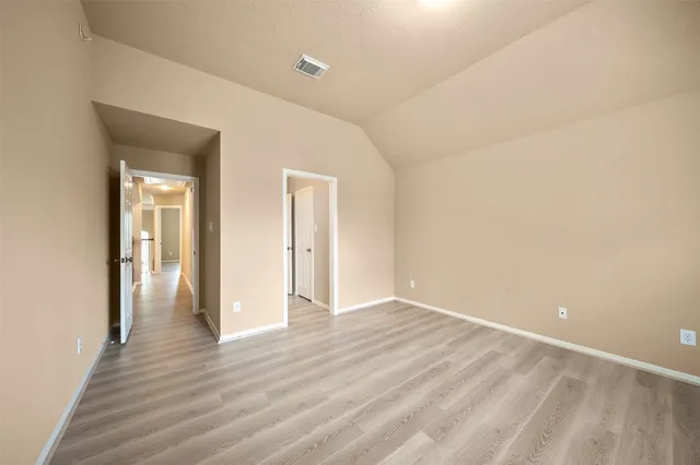 a view of an empty room and wooden floor