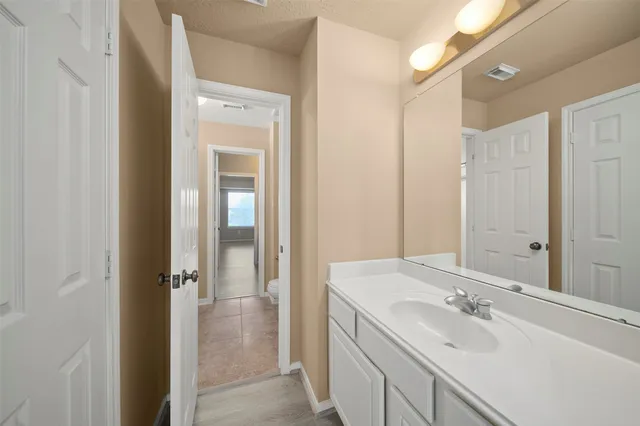 a bathroom with a sink a mirror and a shower