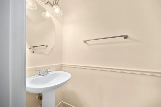 a bathroom with a sink a mirror and a shower