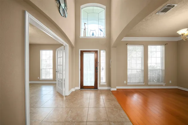 a view of a room with large windows and cabinet