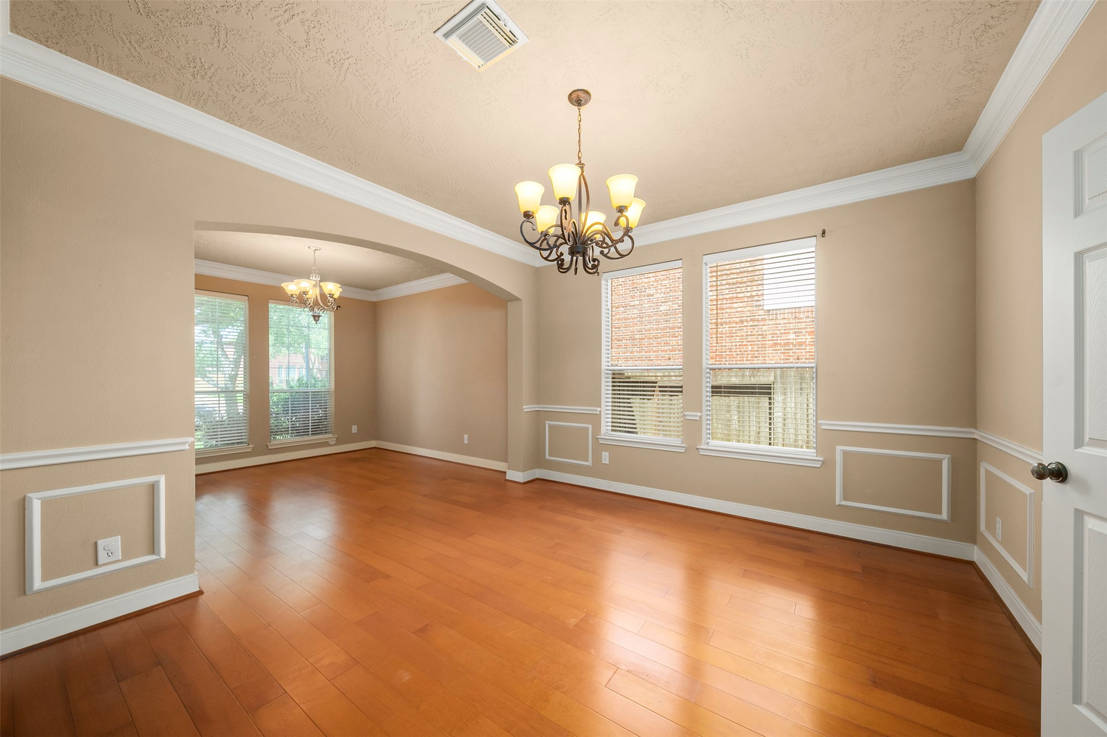 12311 Amanda Meadows Houston, TX 77089 - Photo 6 of 42 a view of an empty room with wooden floor and a window