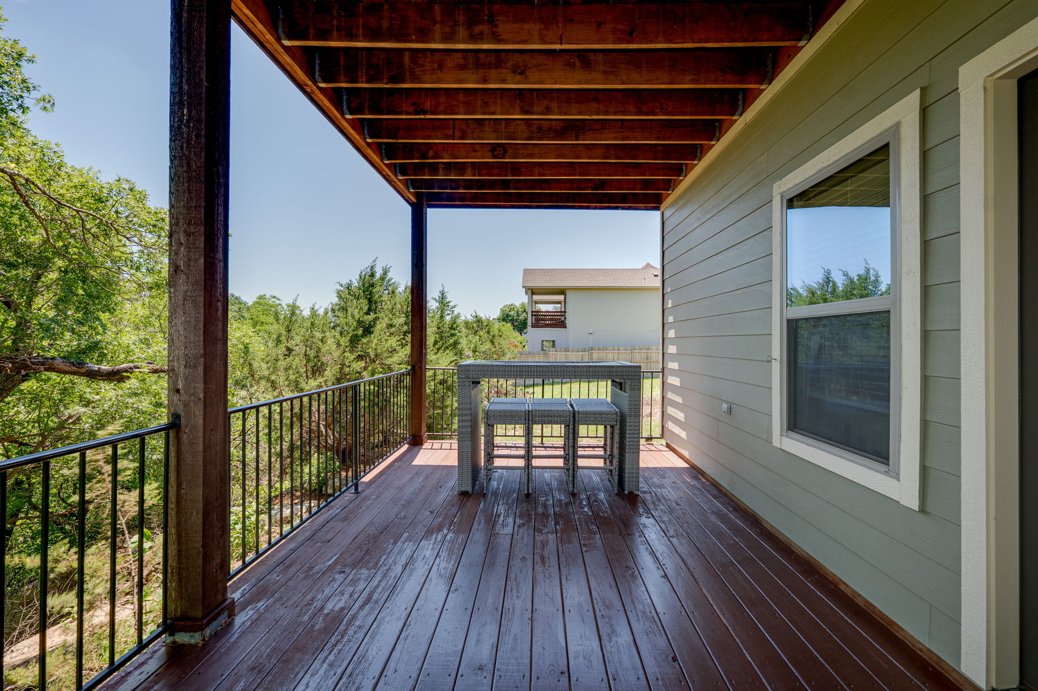 433 Venture Boulevard South Point Venture, TX 78645 - Photo 23 of 36 A lower level deck keeps the treehouse feeling downstairs, giving guests their own quiet spot to enjoy.