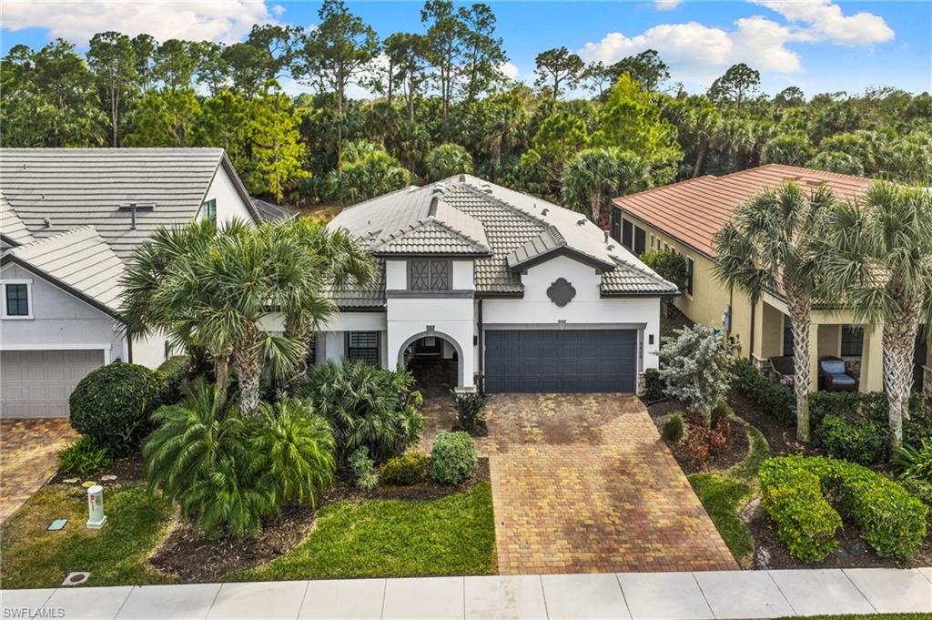 a aerial view of a house with a yard and potted plants