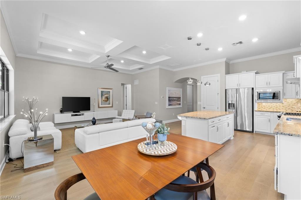 9410 Whooping Crane Way Naples, FL 34120 - Photo 15 of 38 a living room with stainless steel appliances furniture a dining table and kitchen view