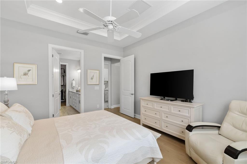 9410 Whooping Crane Way Naples, FL 34120 - Photo 18 of 38 a hotel room with bed and tv