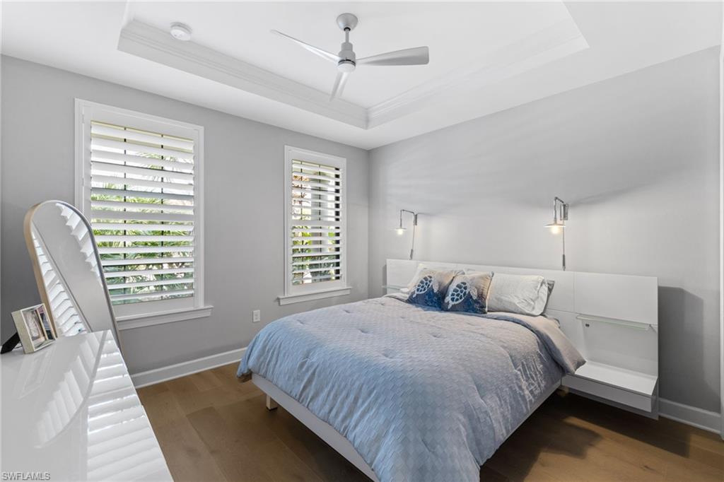 9410 Whooping Crane Way Naples, FL 34120 - Photo 22 of 38 a bedroom with a large bed and a chair