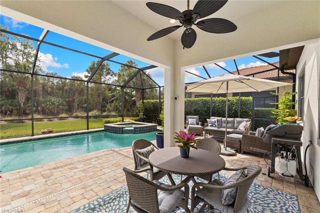 9410 Whooping Crane Way Naples, FL 34120 - Photo 27 of 38 a view of a patio with swimming pool