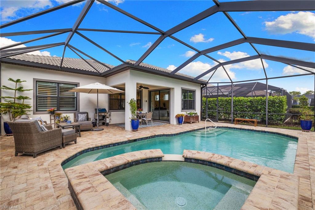 9410 Whooping Crane Way Naples, FL 34120 - Photo 28 of 38 a view of swimming pool with outdoor seating