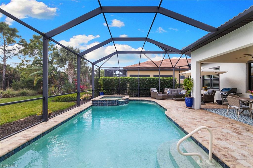 9410 Whooping Crane Way Naples, FL 34120 - Photo 30 of 38 a view of swimming pool with seating area and furniture