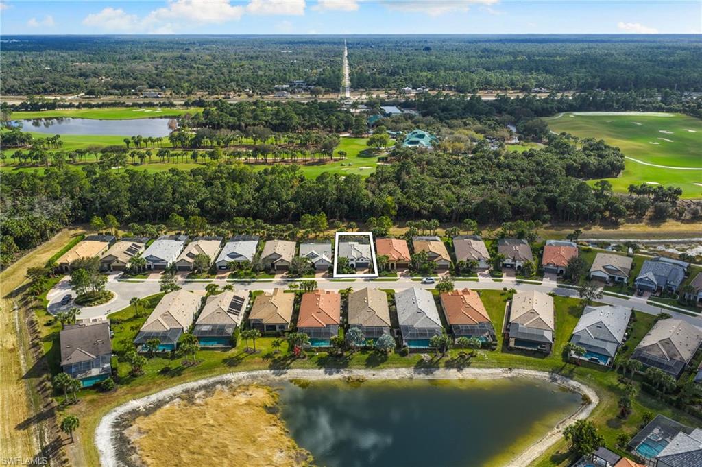 9410 Whooping Crane Way Naples, FL 34120 - Photo 33 of 38 an aerial view of residential houses with outdoor space and lake view