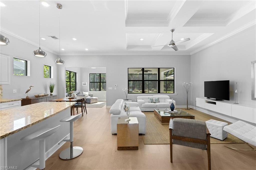 9410 Whooping Crane Way Naples, FL 34120 - Photo 6 of 38 a living room with furniture and a flat screen tv