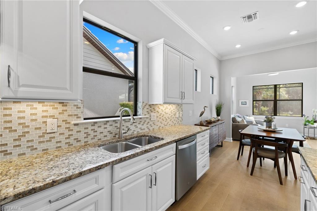 9410 Whooping Crane Way Naples, FL 34120 - Photo 8 of 38 a kitchen with a sink and cabinets