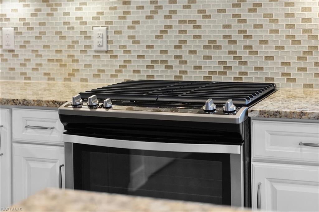 9410 Whooping Crane Way Naples, FL 34120 - Photo 10 of 38 a stove top oven sitting inside of a kitchen
