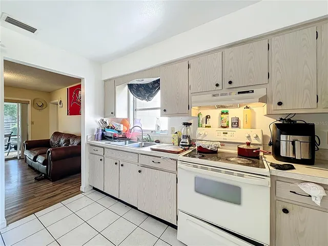 a kitchen with stainless steel appliances a sink stove and cabinets