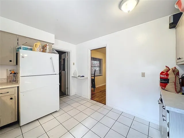 a white refrigerator freezer and a refrigerator in a kitchen