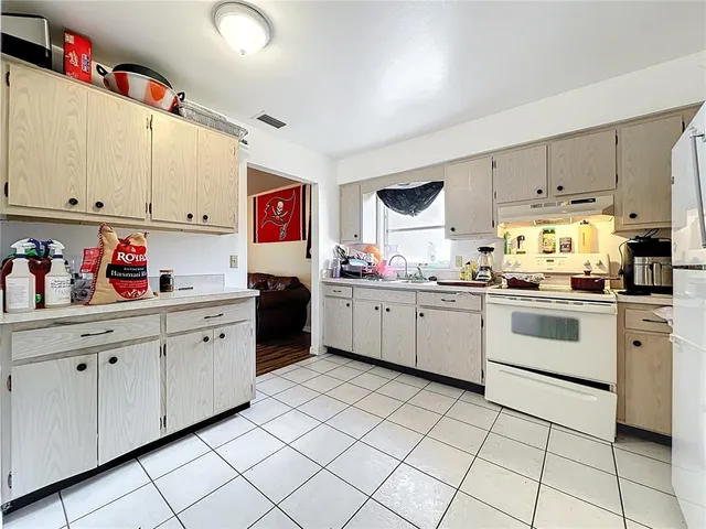 a kitchen with granite countertop cabinets and white appliances