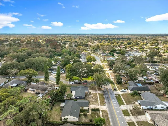 an aerial view of residential houses with city view