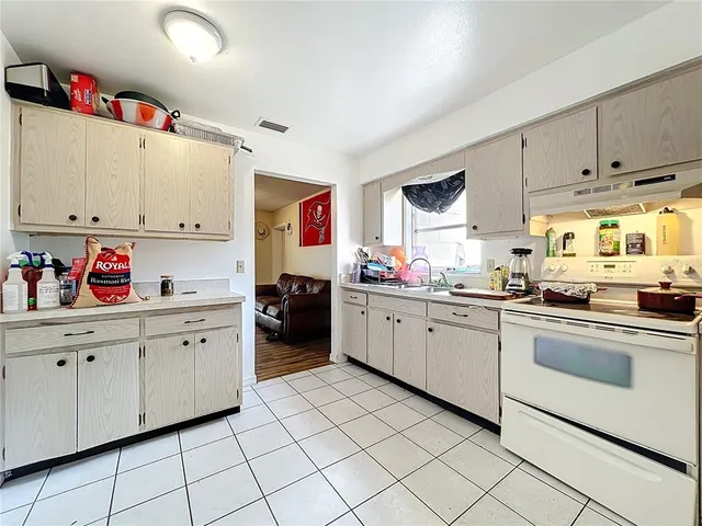 a kitchen with white cabinets and white appliances