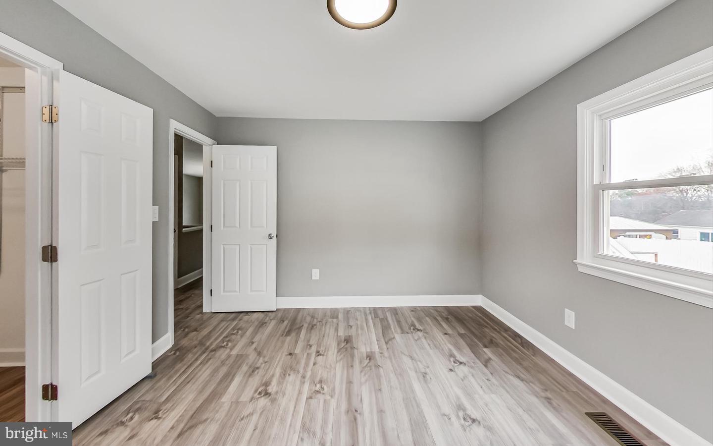 5923 Berwyn Road College Park, MD 20740 - Photo 15 of 51 a view of empty room with wooden floor and fan