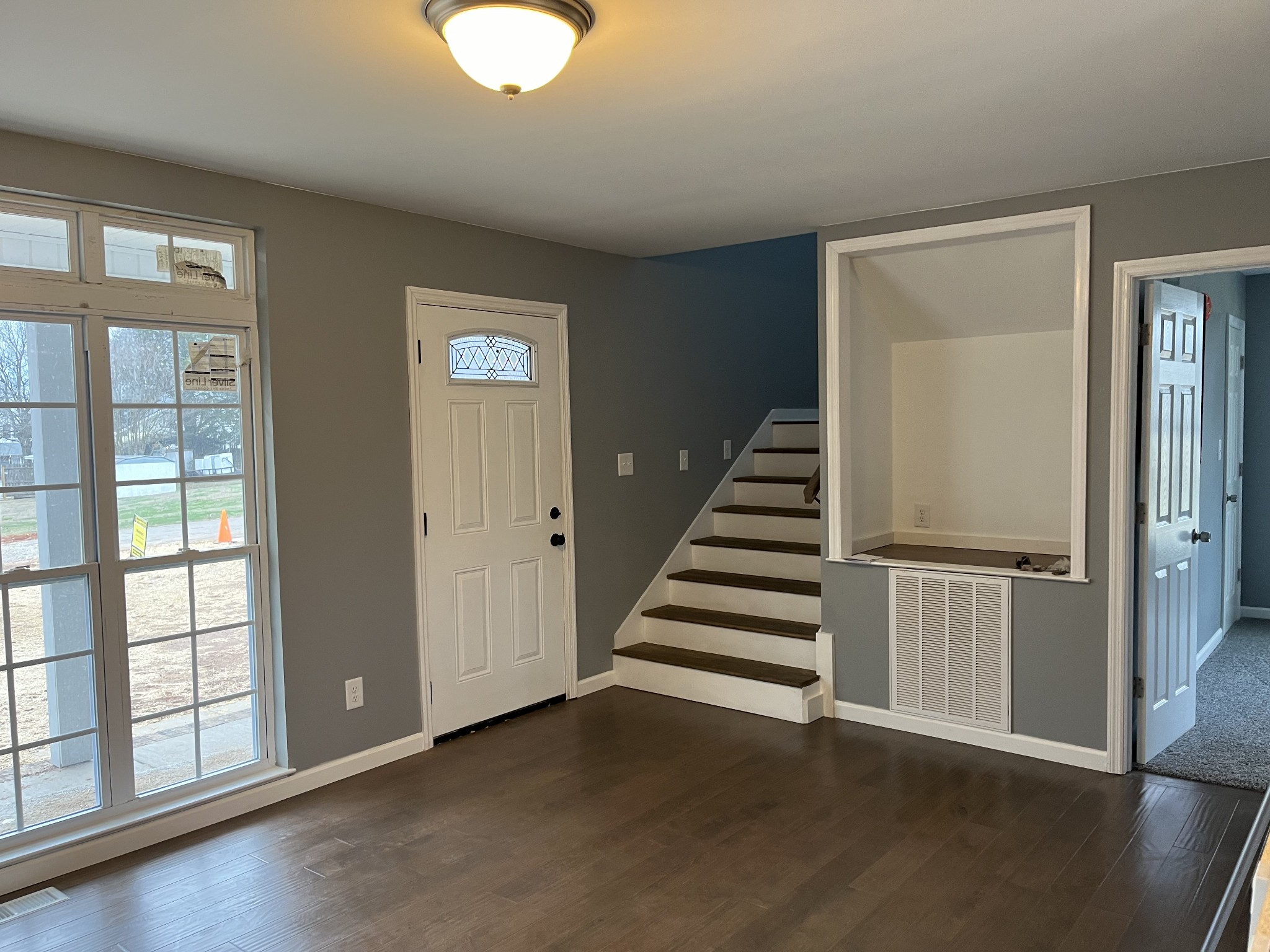 203 5th Avenue North Decherd, TN 37324 - Photo 3 of 13 a view of an empty room with wooden floor and windows