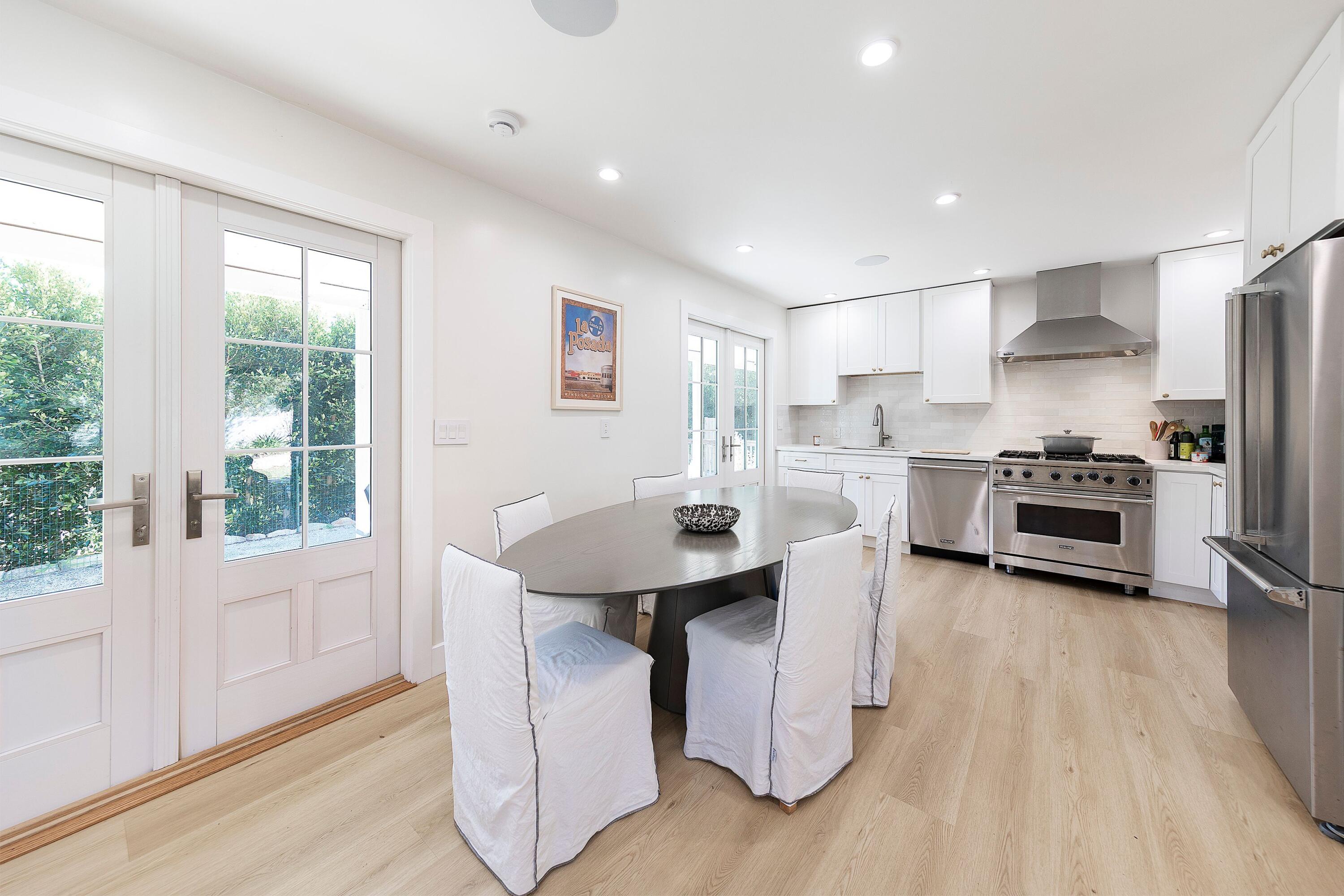 487 Hot Springs Road Santa Barbara, CA 93108 - Photo 22 of 47 a kitchen with stainless steel appliances kitchen island granite countertop a stove a sink a refrigerator and white cabinets with wooden floor