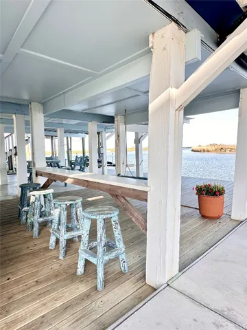a large hall with wooden floor and furniture