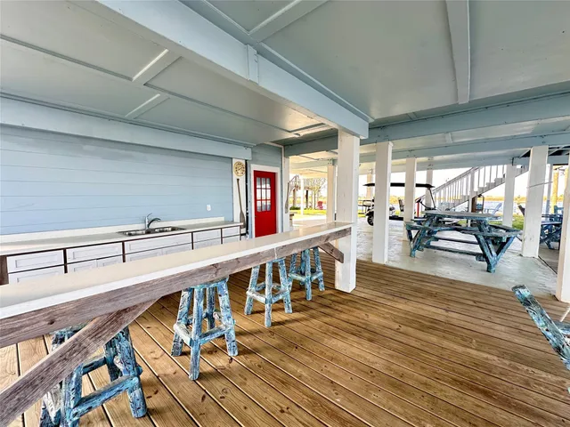 a kitchen with white cabinets stainless steel appliances and sink