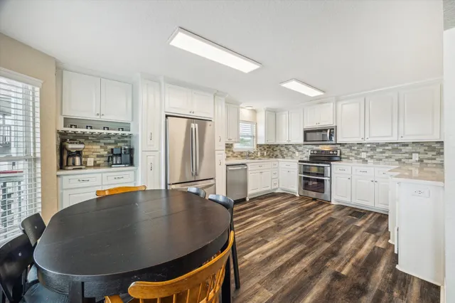 a bathroom with a granite countertop sink a toilet and a shower