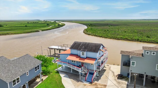an aerial view of a house with a yard basket ball court and outdoor seating